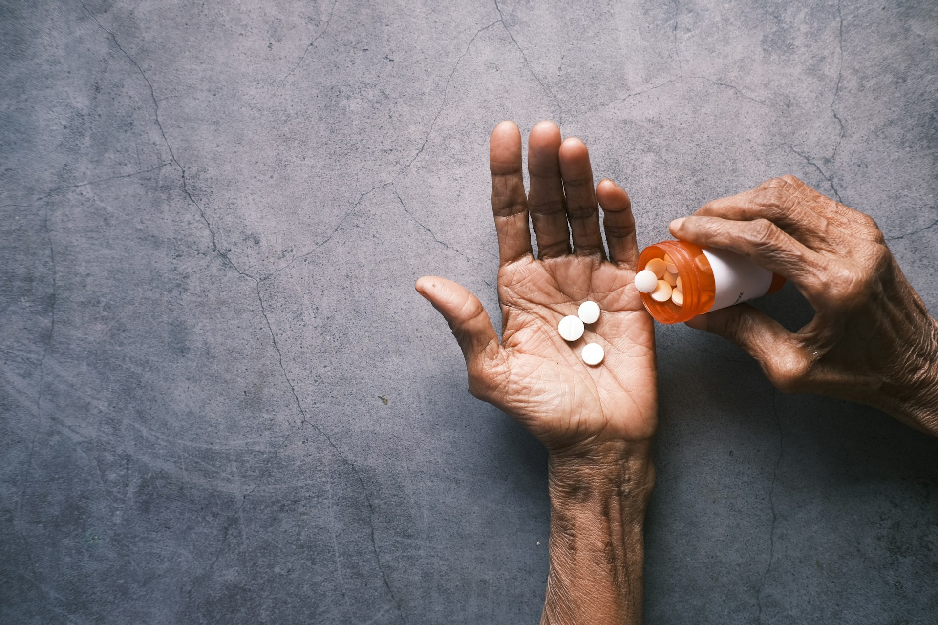 Hand Pouring Pills Into Palm